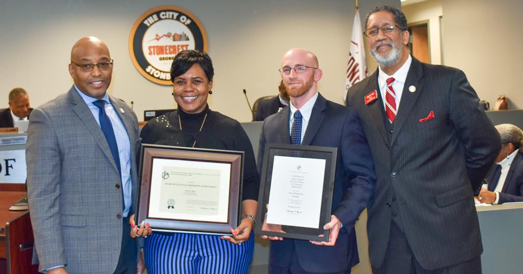 In the photo (l-r) Michael Harris, City Manager; Audrey Mays, City Accounts Manager; James Pence of Mauldin and Jenkins; Mayor Jason Lary.
